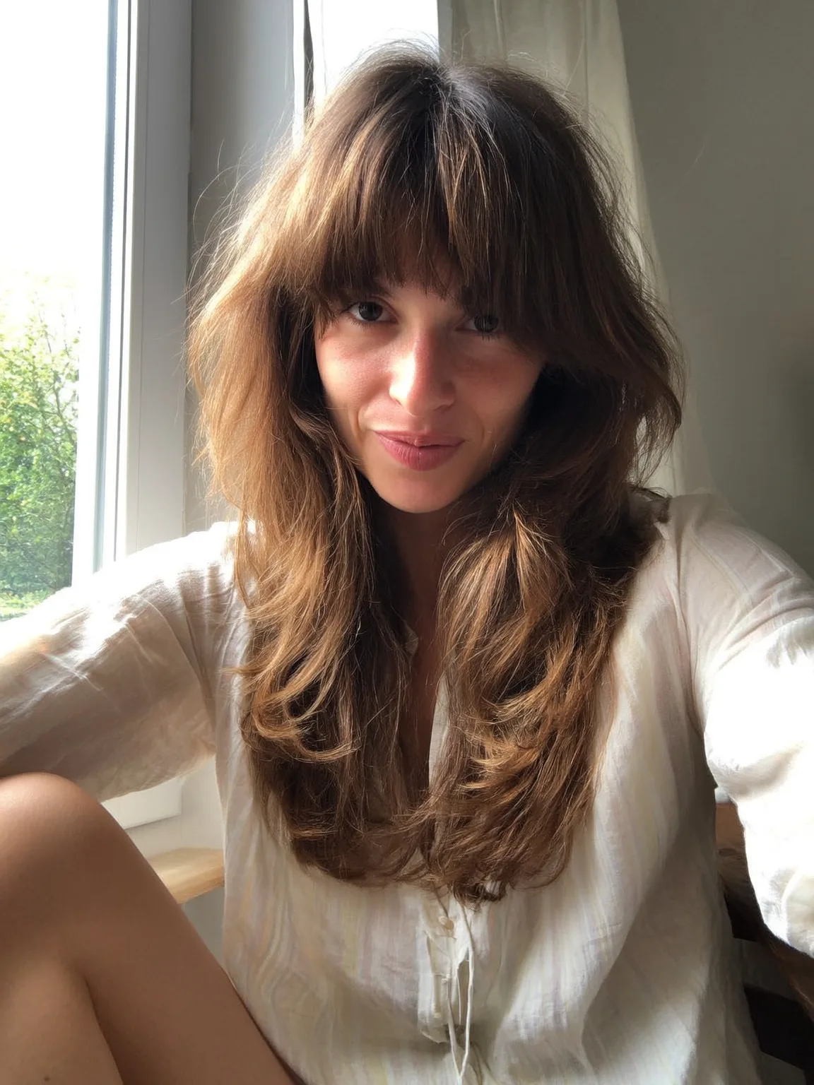 Oval-Flattering Warm Caramel Brown Long Layers with Blunt Bangs
